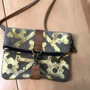 Mona B. Fold over crossbody bag. Tan/gold design.